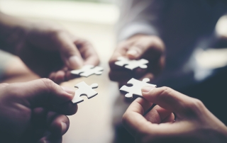 Hand holding jigsaw puzzles