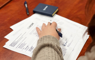 A woman signs a HAP contact with HOM
